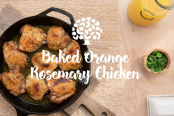 image of baked orange rosemary chicken in a cast iron skillet