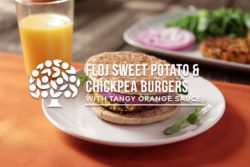 floj sweet potato chickpea burger on plate next to glass of orange juice