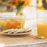 soup, crackers and a glass of orange juice