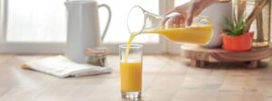Orange Juice being poured into a glass image
