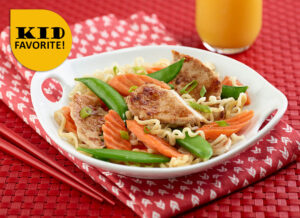 Ramen Stir Fry topped with greens and pork.