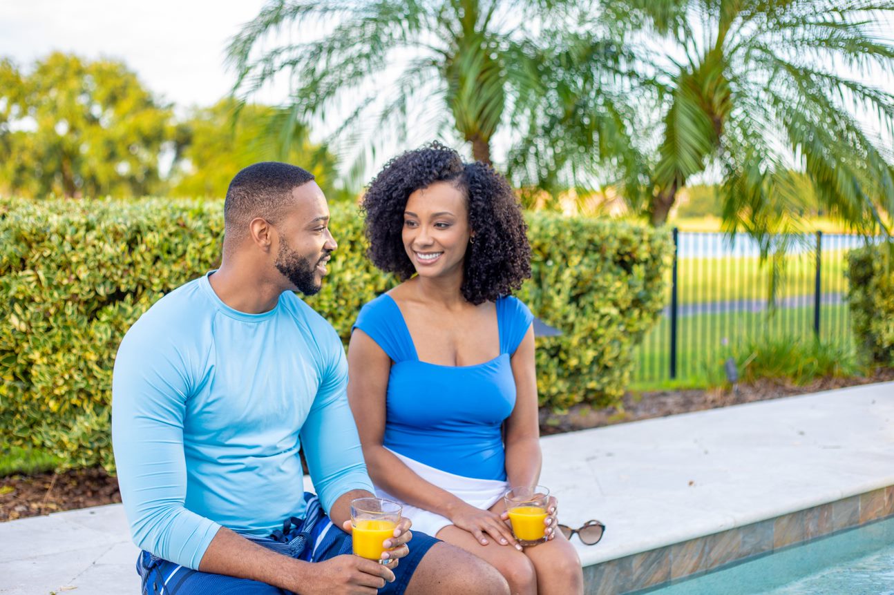 Man and woman drinking orange juice