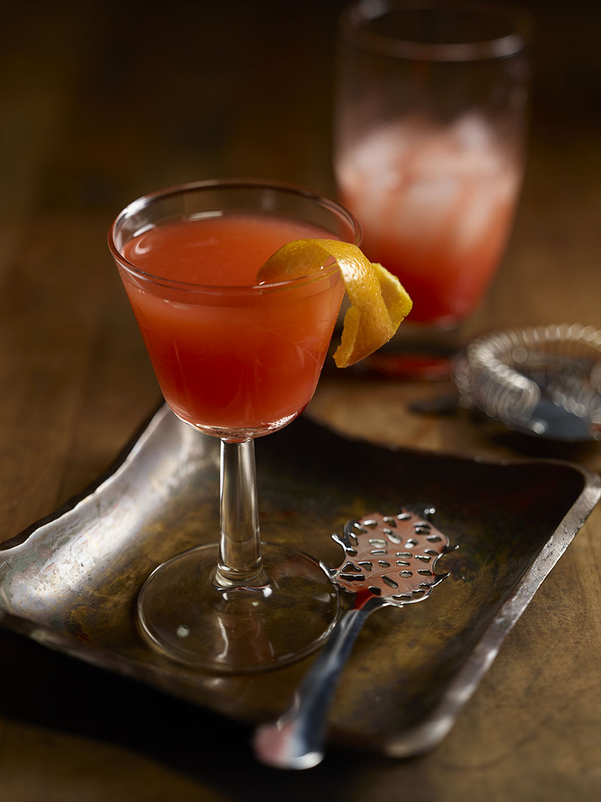 Sunburst Sazerac in a small glass with a grapefruit garnish