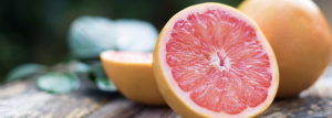 sliced grapefruit on wood table