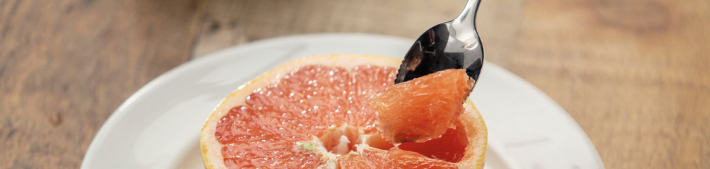 spoon in a sliced grapefruit