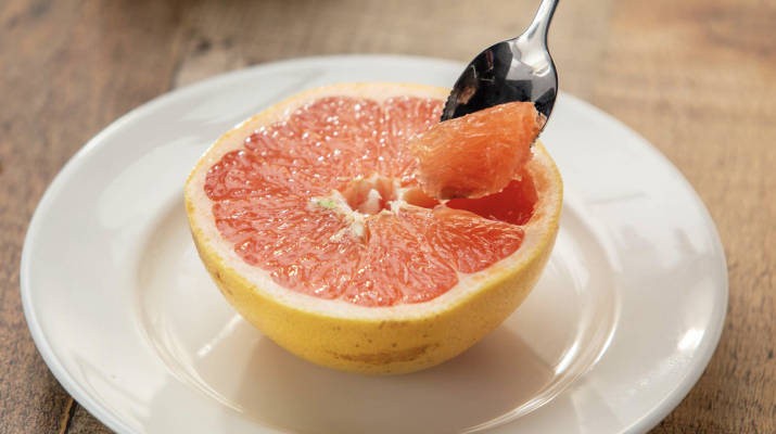 spoon in a sliced grapfruit