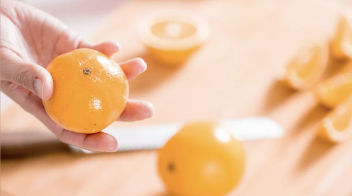 person cutting tangerines