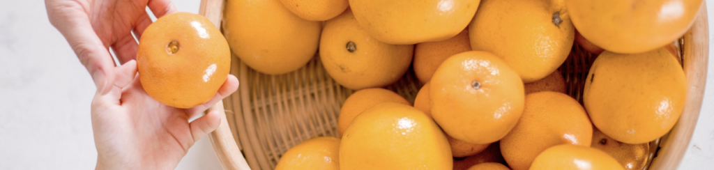 basket full of tangerines on counter