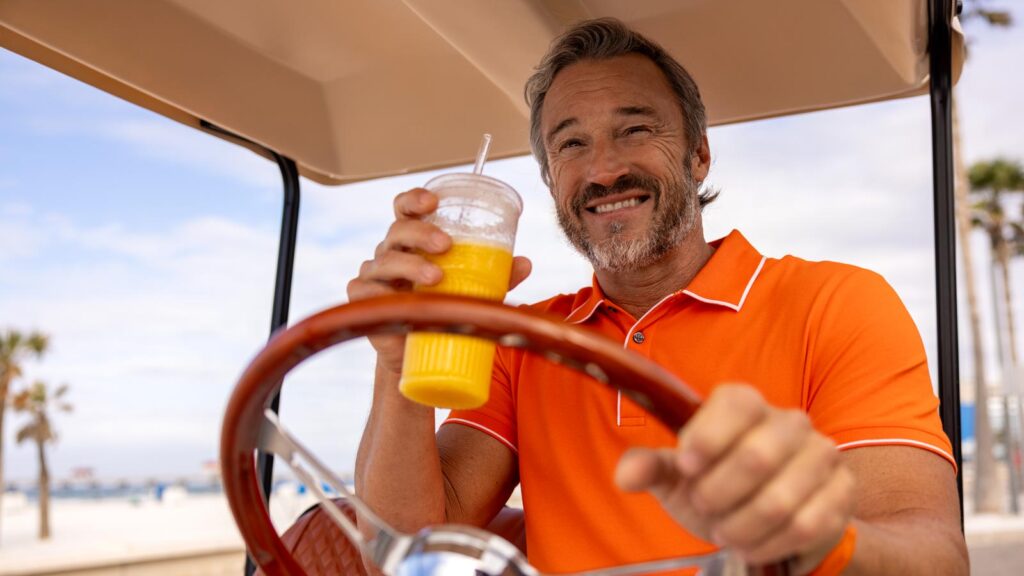 man enjoying life sipping orange juice